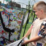 Garrett, Scarlett’s brother who unveiled a special piece of artwork in her honour at the recent reopening of the newly refurbished play park at Bardic Drive, Larne.