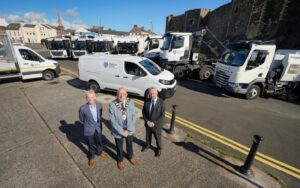 Mayor Jackson Minford with Council staff and new refuse collection vehicles.