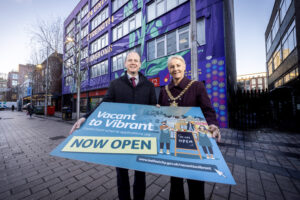 Minister for Communities Gordon Lyons is pictured with Belfast Lord Mayor Councillor Tracy Kelly outside Arts Ekta’s five storey cultural and creative hub, ‘Olive Tree House’ at 23-29 Fountain Street, which was created with the help of a Vacant to Vibrant grant. Following successful a Vacant to Vibrant City Centre and phase one of the Vacant to Vibrant Citywide grant programme, £700k in capital funding is now available (£500k from the Department for Communities and £200k from Belfast City Council) to incentivise and support property owners and potential occupiers to bring vacant properties back into use outside the city centre, in local neighbourhoods. To find out more about making a Vacant to Vibrant Citywide application and for details of funding information sessions,