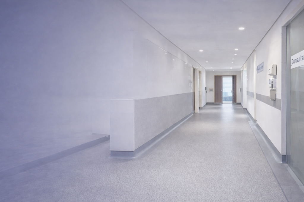 Floorkraft NI commercial flooring supply and fit specialists banner with healthcare sheet vinyl flooring corridor