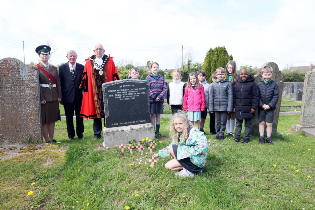 Pupils from Ballycarry Primary School laid poppy crosses on the Hutchinson and McCready graves to remember the adults and children who lost their lives 85 years ago. Pictured with them are Cadet Ruby Maxwell, The Lord Lieutenant of County Antrim, David McCorkell KSt.J and Mayor of Mid and East Antrim, Councillor Jackson Minford