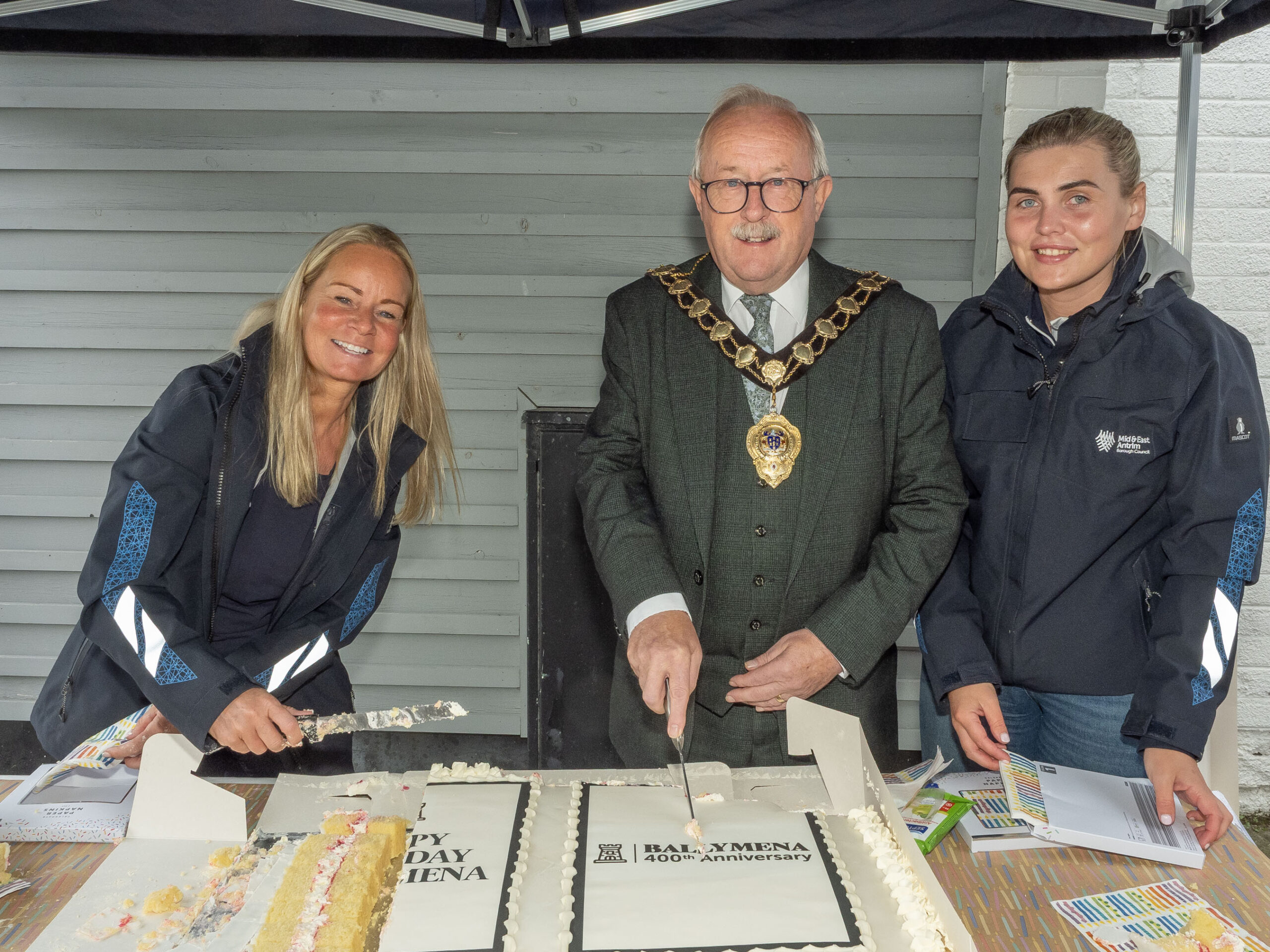 Mayor of Mid and East Antrim, Alderman Thomas Gordon, helps cut Ballymena's birthday cake