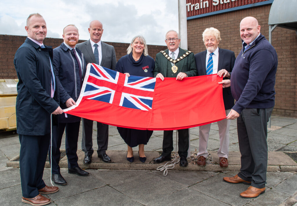 Pictured (l-r) with the Mayor of Mid and East Antrim, Alderman Thomas Gordon at the Red Ensign flag raising at Larne Harbour are: Matt McDowell, Director of People, Mid and East Antrim Borough Council; John Stewart MLA; Rowan Moore, Director of Place Mid and East Antrim Borough Council; Jane Allen DL, Deputy Lieutenant for County Antrim; Alderman Robert Logan and Councillor Matthew Warwick.