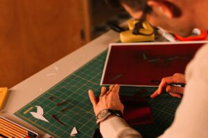Illustrative paper-craft activity with tools and coloured paper; not the Flying Island workshop.